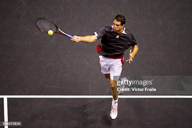 Guillermo Garcia-Lopez of Spain returns a ball to Jarkko Nieminen of Finland in the singles final match on Day 9 of the PTT Thailand Open at Impact...