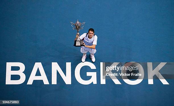 Guillermo Garcia-Lopez of Spain poses with the trophy after winning the singles final match against Jarkko Nieminen of Finland on Day 9 of the PTT...