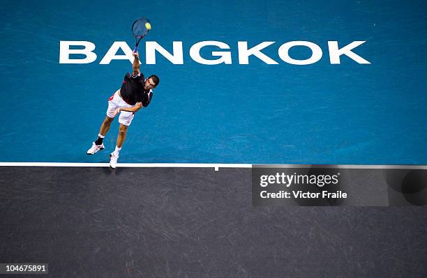 Guillermo Garcia-Lopez of Spain serves against Jarkko Nieminen of Finland in the singles final match on Day 9 of the PTT Thailand Open at Impact...