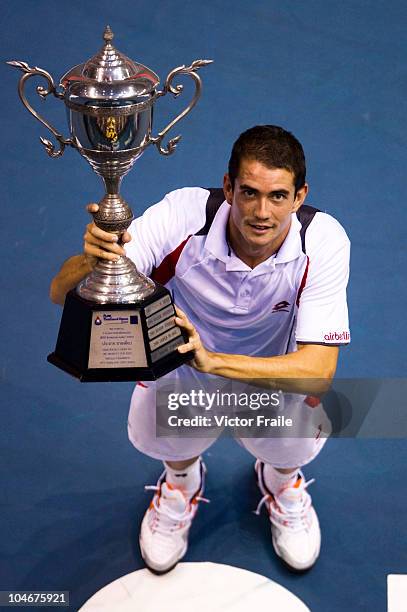 Guillermo Garcia-Lopez of Spain poses with the trophy after winning the singles final match against Jarkko Nieminen of Finland during the Day 9 of...