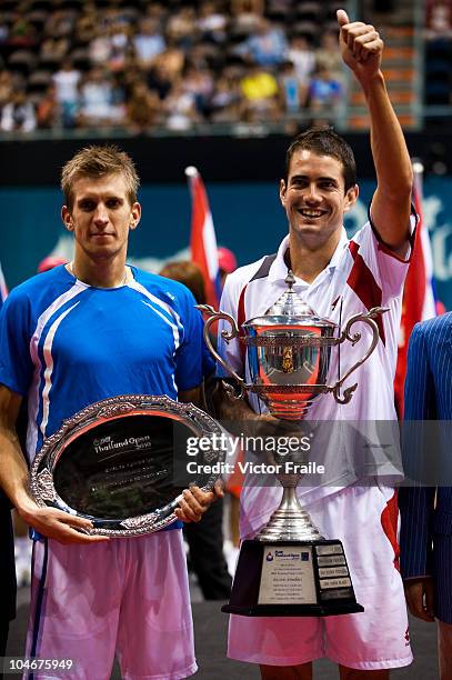 Guillermo Garcia-Lopez of Spain and Jarkko Nieminen of Finland pose with their trophies at the end of the singles final match during the Day 9 of the...