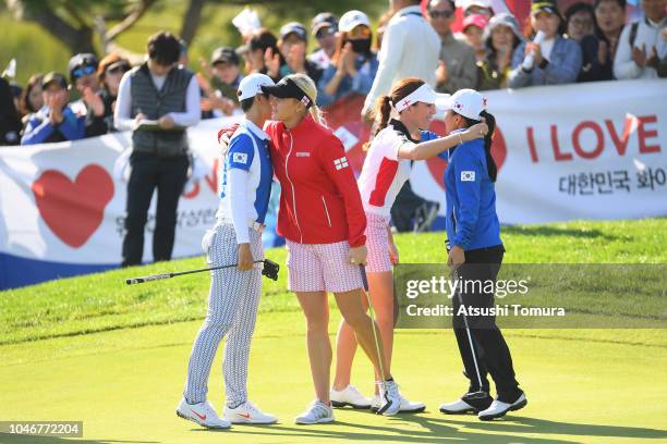 Sung Hyun Park and In-Kyung Kim of South Korea congratulated by Charley Hull and Georgia Hall of England after their victory on the 16th green in the...