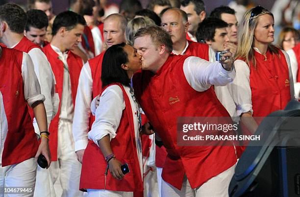 England athletes kiss as they take part in the opening ceremony of the XIX Commonwealth Games in New Delhi on October 3, 2010. The 2010 Commonwealth...