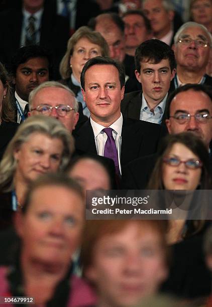 Prime Minister David Cameron sits in the audience as he listens to speeches at the Conservative Party Conference at the International Convention...