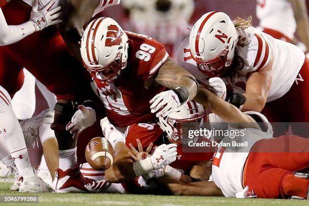 Olive Sagapolu of the Wisconsin Badgers recovers a fumble in the third quarter against the Nebraska Cornhuskers at Camp Randall Stadium on October 6,...
