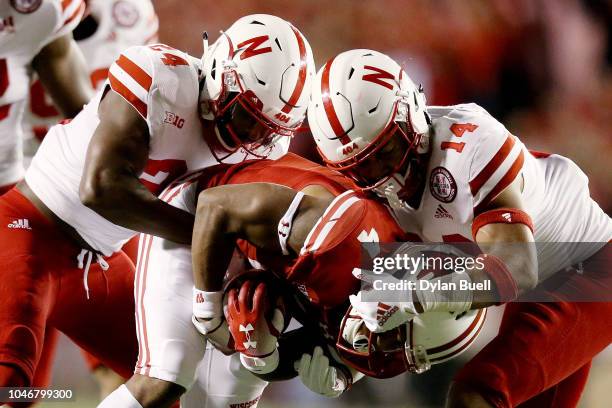 Aaron Williams and Tre Neal of the Nebraska Cornhuskers tackle A.J. Taylor of the Wisconsin Badgers in the second quarter at Camp Randall Stadium on...
