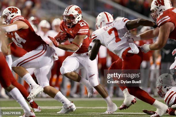 Jonathan Taylor of the Wisconsin Badgers runs with the ball in the first quarter against the Nebraska Cornhuskers at Camp Randall Stadium on October...
