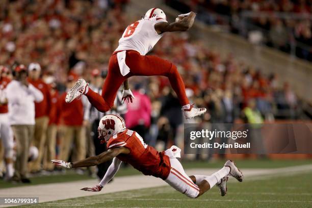 Stanley Morgan Jr. #8 of the Nebraska Cornhuskers leaps over Deron Harrell of the Wisconsin Badgers in the second quarter at Camp Randall Stadium on...