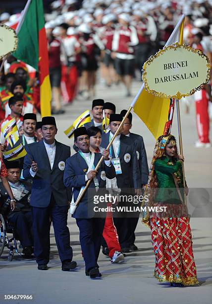 Brunei Darussalam athletes led by flag bearer Ampuan Ahad take part in the opening ceremony of the XIX Commonwealth Games in New Delhi on October 3,...