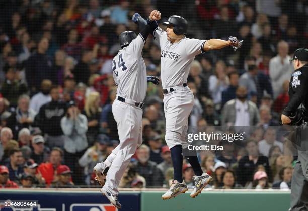Gary Sanchez and Giancarlo Stanton of the New York Yankees celebrate after Sanchez hit a three-run home run during the seventh inning of Game Two of...