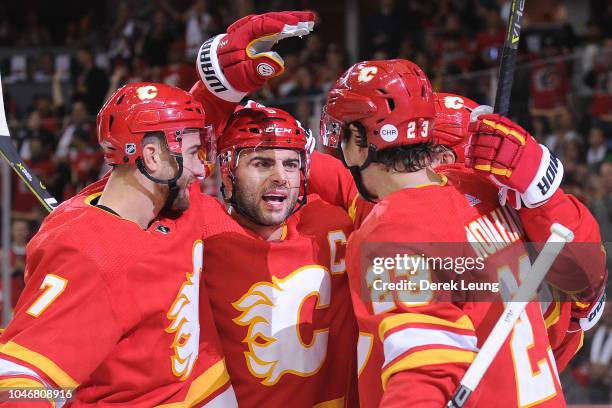 The Calgary Flames celebrate after Elias Lindholm scored their first goal against the Vancouver Canucks during an NHL game at Scotiabank Saddledome...