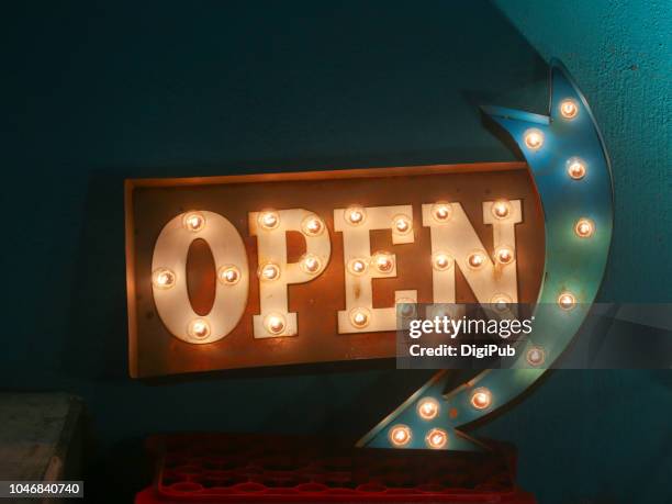 electric bulb open sign with arrow - open sign stock pictures, royalty-free photos & images