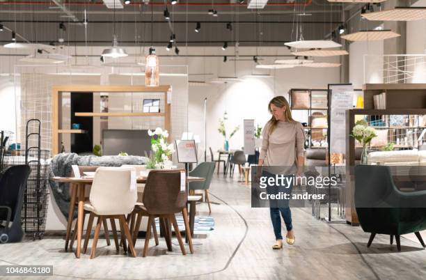 happy woman shopping at a furniture store - furniture stock pictures, royalty-free photos & images