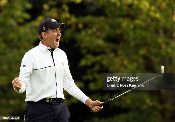 Ian Poulter of Europe celebrates holing a putt on the 15th green during the Fourball & Foursome Matches during the 2010 Ryder Cup at the Celtic Manor...