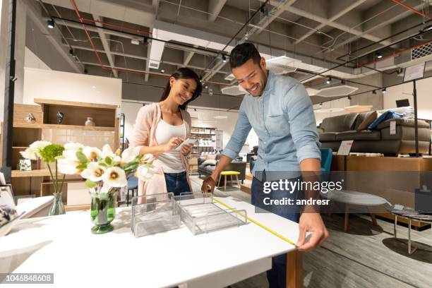 happy couple shopping furniture at store - buying furniture stock pictures, royalty-free photos & images