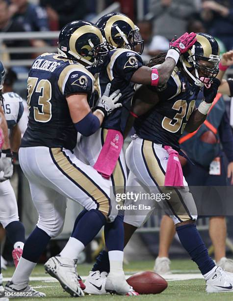 Steven Jackson of the St. Louis Rams is congratulated by teammates Kenneth Darby and Adam Goldberg in the fourth quarter against the Seattle Seahawks...