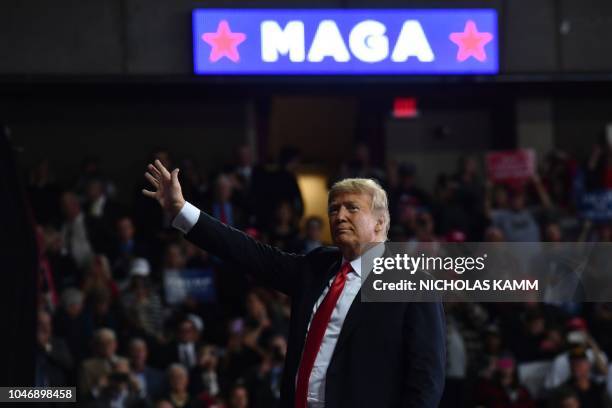 President Donald Trump waves during a "Make America Great Again" rally in Topeka, Kansas, on October 6, 2018.