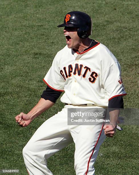 Freddy Sanchez of the San Francisco Giants celebrates after scoring a run during the third inning against the San Diego Padres at AT&T Park on...