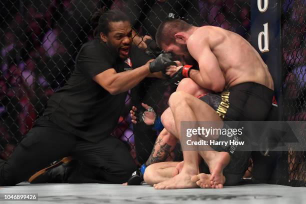 Referee Herb Dean separates Khabib Nurmagomedov of Russia from Conor McGregor of Ireland after McGregor tapped out in their UFC lightweight...