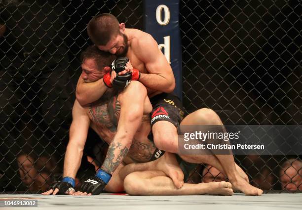 Conor McGregor of Ireland is held by Khabib Nurmagomedov of Russia before submitting in defeat in their UFC lightweight championship bout during the...