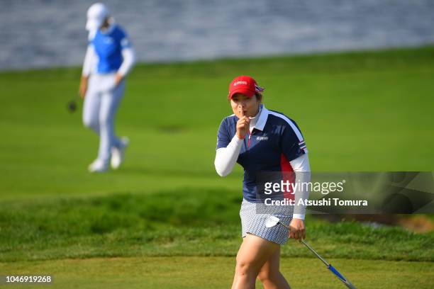 Ariya Jutanugarn of Thailand gestures while walking on the 17th fairway during the Singles match against Sung Hyun Park of South Korea on day four of...