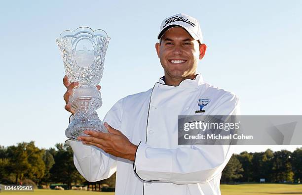 Bill Haas holds the trophy and wears the winner's chef's jacket after winning the Viking Classic held at Annandale Golf Club on October 3, 2010 in...