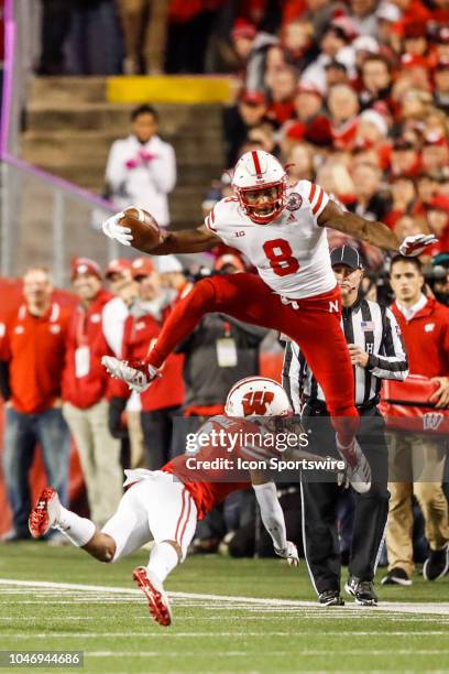 Nebraska wide receiver Stanley Morgan Jr. Leaps over Wisconsin cornerback Deron Harrell during a college football game between the University of...