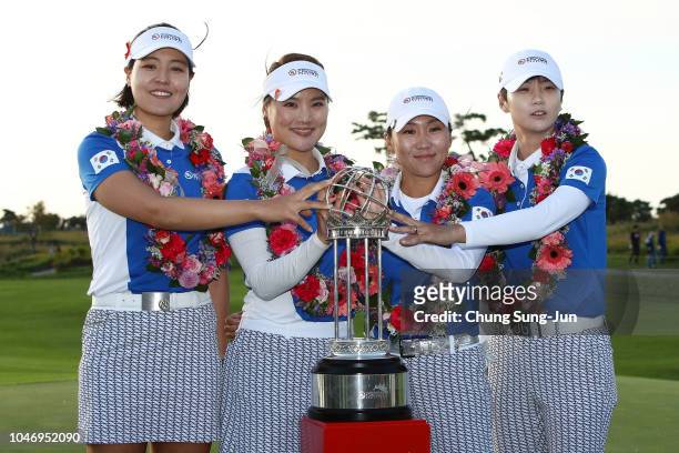 In Gee Chun, So Yoen Ryu, In-Kyung Kim and Sung Hyun Park of South Korea pose for photographs with the trophy after winning the UL International...