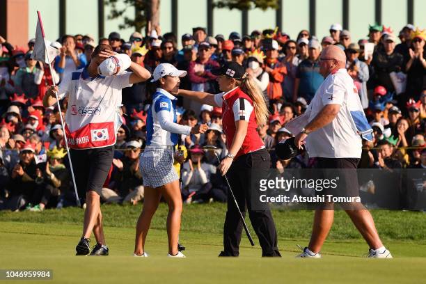 In Kyung-Kim of South Korea is congratulated by Bronte Law of England after her victory on the 18th green during the Singles match on day four of the...