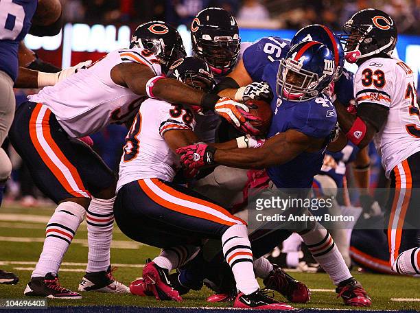 Ahmad Bradshaw of the New York Giants runs the ball for a touchdown against Charles Tillman, Danieal Manning and Mark Anderson of the Chicago Bears...