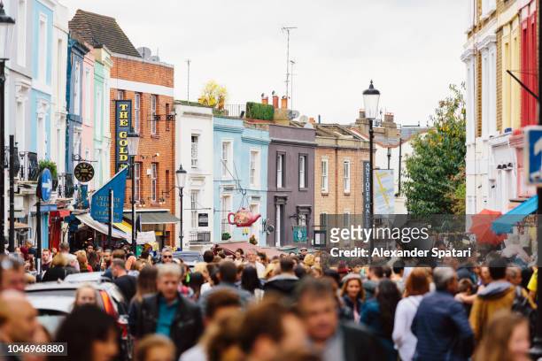 crowded street at portobello road market in notting hill, london, uk - city street ストックフォトと画像