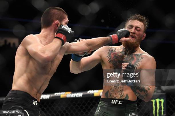 Khabib Nurmagomedov of Russia punches Conor McGregor of Ireland in their UFC lightweight championship bout during the UFC 229 event inside T-Mobile...