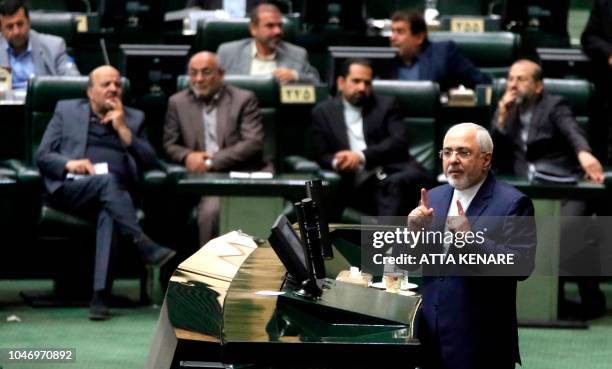 Iran's Foreign Minister Mohammad Javad Zarif delivers a speech to the parliament in Tehran on October 7 over the a bill to counter terrorist...