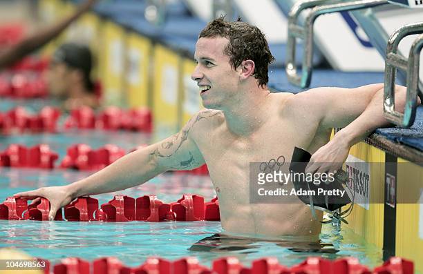 Daniel Bell of New Zealand finishes the Men's 50m Backstroke Heat 3 in first place at the Dr. S.P. Mukherjee Swimming Complex during day one of the...