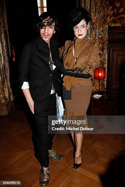 John Galliano and Dita von Teese attend the John Galliano Ready to Wear Spring/Summer 2011 show during Paris Fashion Week at Opera Comique on October...