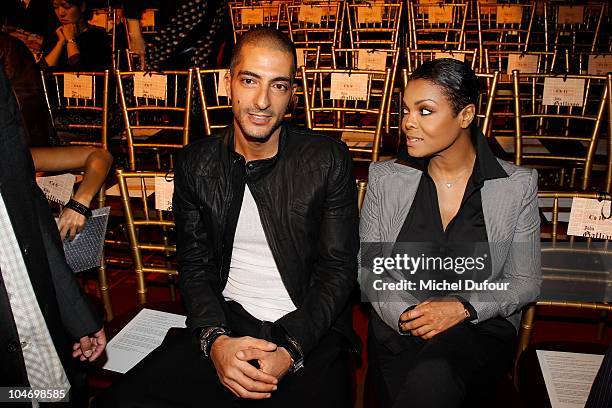 Wissam Al Mana and Janet Jackson attend the John Galliano Ready to Wear Spring/Summer 2011 show during Paris Fashion Week at Opera Comique on October...