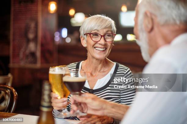 senior couple drinking beer - senior men beer stock pictures, royalty-free photos & images