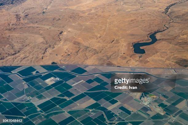 aerial view of the bound separate mountain and farming valley - spring mountains stock pictures, royalty-free photos & images