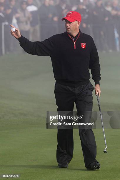 Stewart Cink of the USA waves to the gallery on the third green in the singles matches during the 2010 Ryder Cup at the Celtic Manor Resort on...