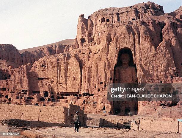 File photo dated 07 December 1997 shows an Afghan walking near the world's tallest standing statue of Buddha in Bamiyan province of Afghanistan. In a...