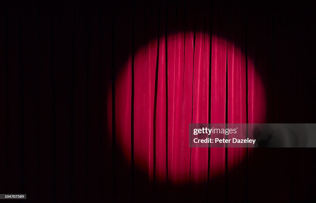 Spot light on red theatre curtains