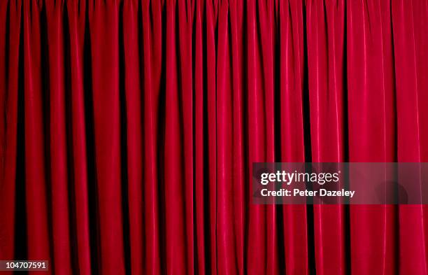 closed red theatre curtains - red curtain stock-fotos und bilder