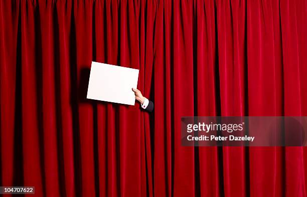 announcement in front of red theatre curtains - theatre curtains stock pictures, royalty-free photos & images