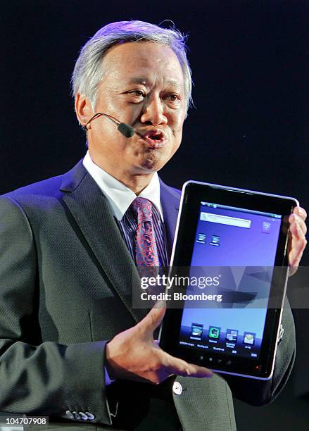 Masaaki Osumi, corporate senior vice president of Toshiba Corp. And president of Visual Products Compan, unveils the company's tablet PC Folio 100,...