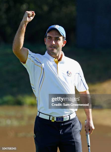 Edoardo Molinari of Europe celebrates holing a putt on the 3rd green in the singles matches during the 2010 Ryder Cup at the Celtic Manor Resort on...