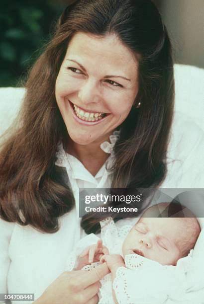 Queen Silvia of Sweden with her baby daughter Princess Victoria at Solliden Castle on August 02, 1977.