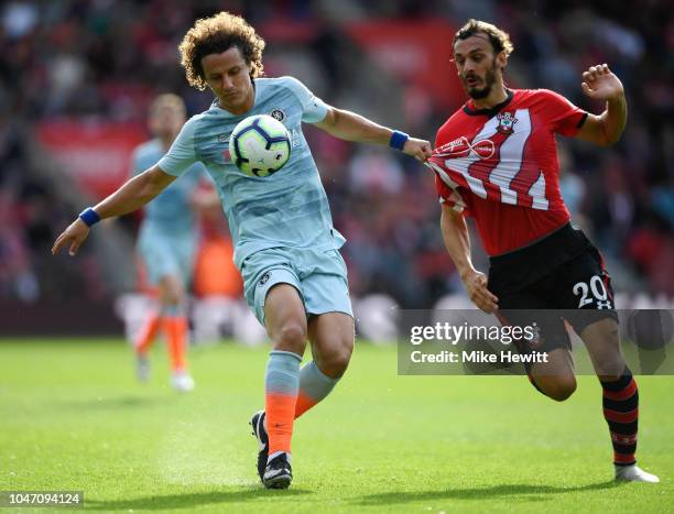 David Luiz of Chelsea battles for possession with Manolo Gabbiadini of Southampton during the Premier League match between Southampton FC and Chelsea...