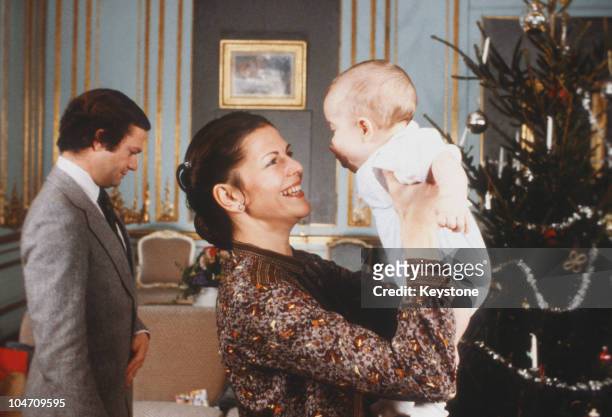 King Carl XVI Gustaf and Queen Silvia of Sweden with their baby son Prince Carl Philip in December 1979.