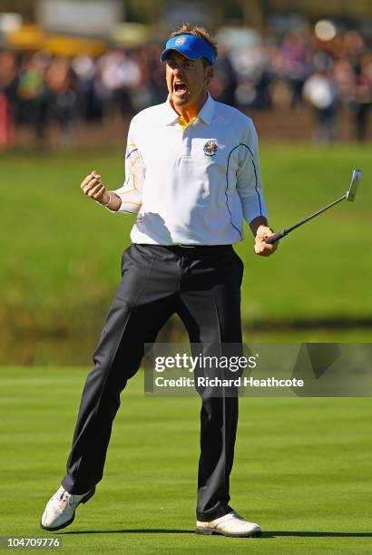 Ian Poulter of Europe celebrates holing a putt on the 13th green in the singles matches during the 2010 Ryder Cup at the Celtic Manor Resort on...