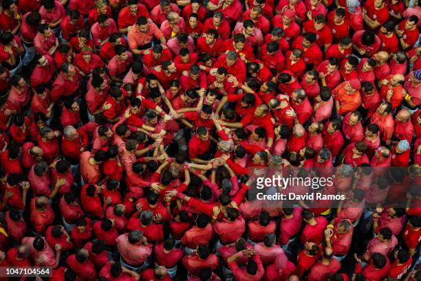 Members of the colla Castellers de Barcelona build a human tower during the 27th Concurs de Castells competition on October 7, 2018 in Tarragona,...
